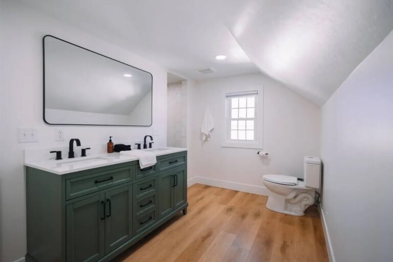 Hunter Green Vanity with Hardwoods and black fixtures installed in Bathroom Remodel Fort Worth Project
