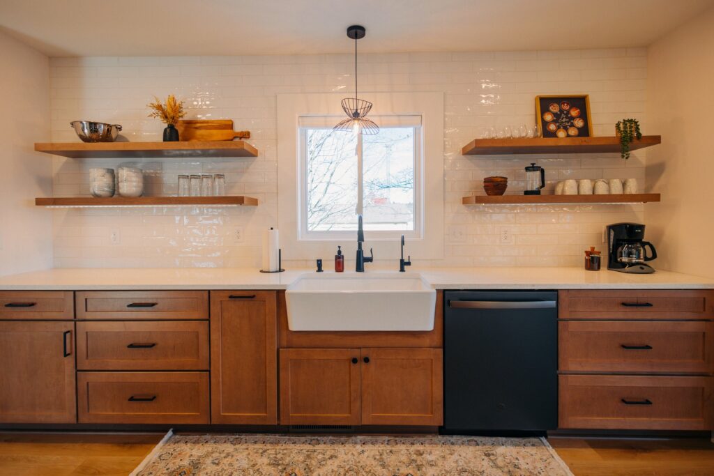 Kitchen remodel in Argyle, TX with a farmhouse sink, wood cabinets, and floating shelves