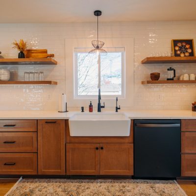 Kitchen remodel in Argyle, TX with a farmhouse sink, wood cabinets, and floating shelves